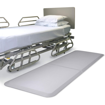 Hospital bed with a large mat in front on a white background